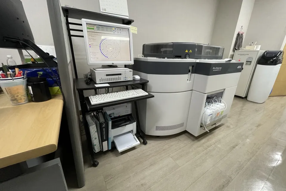 창원 소재 병원 검사실에 설치된 JEOL JCA-BM6010/C 생화학분석기와 왼쪽의 제어용 컴퓨터, 프린터 받침대.